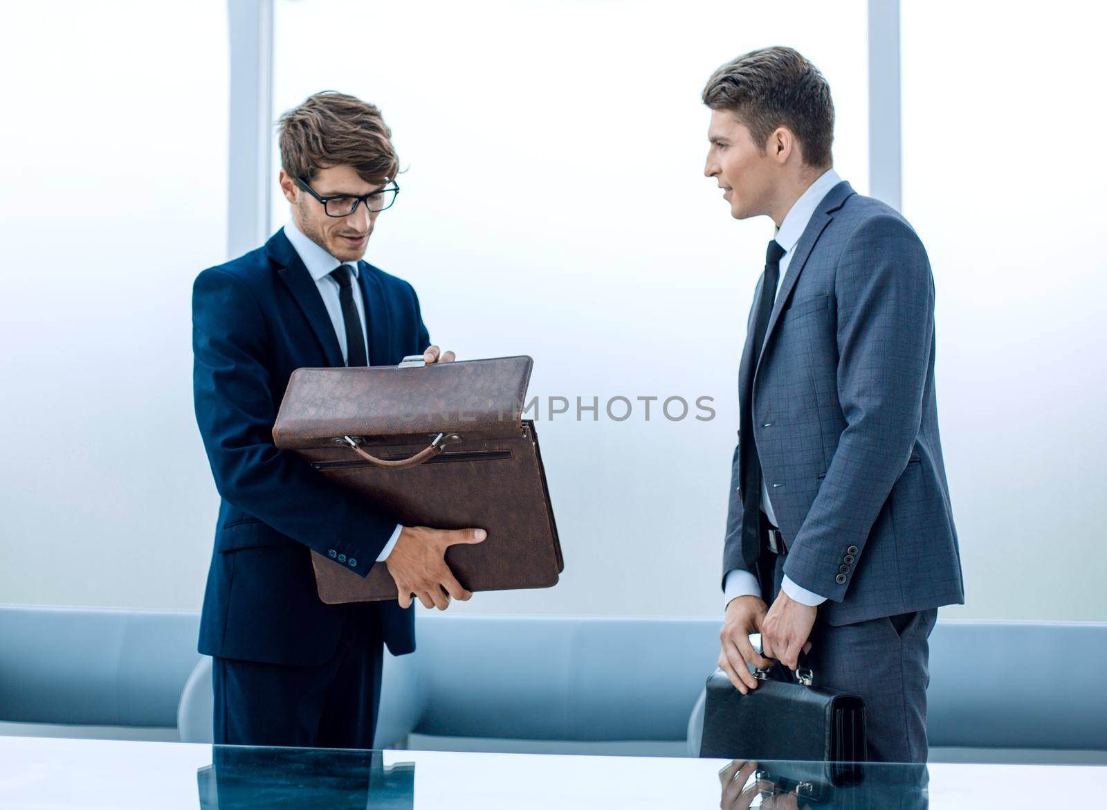 two business people talking standing in the office by asdf