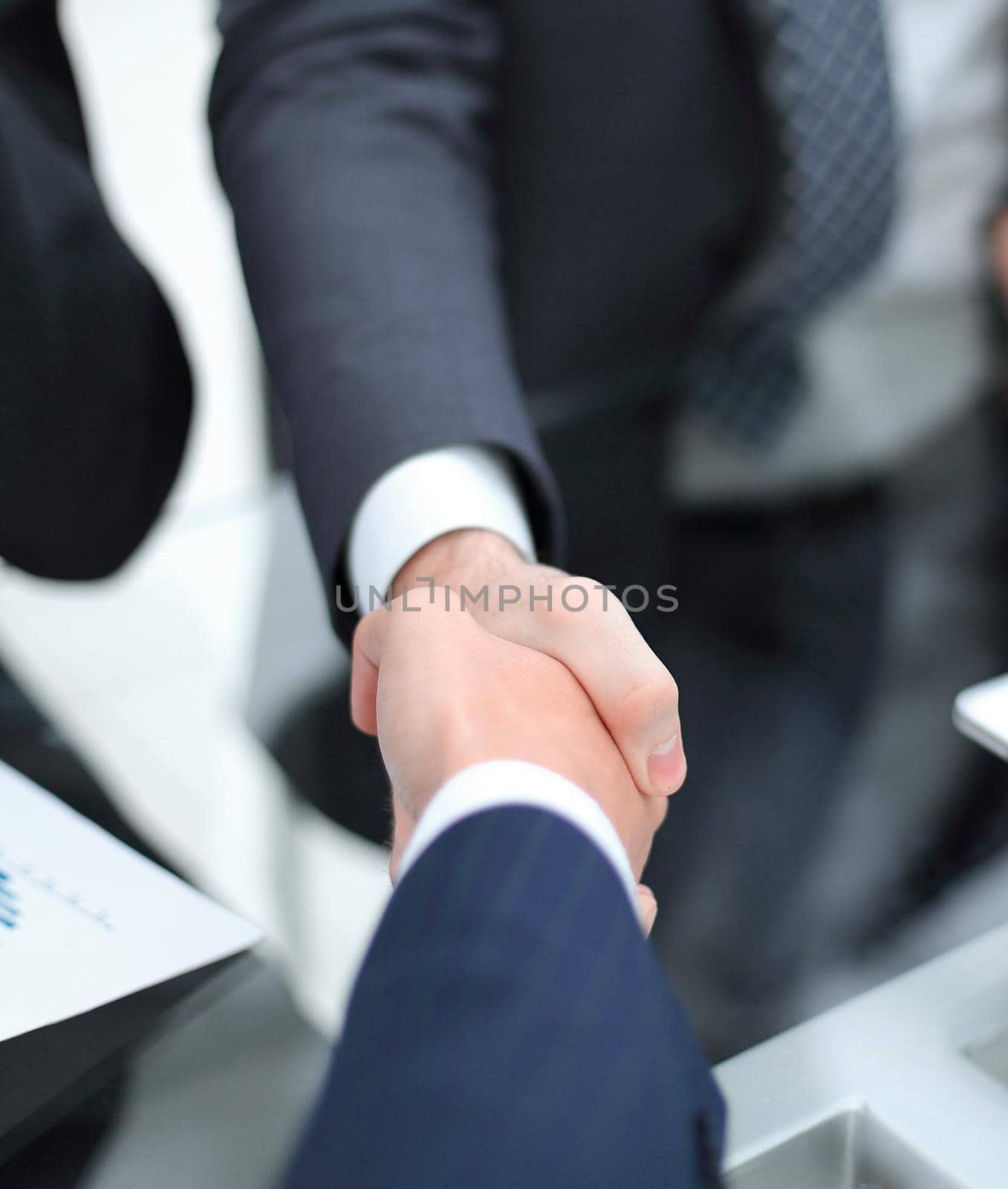 Close up of businessmen shaking hands by asdf