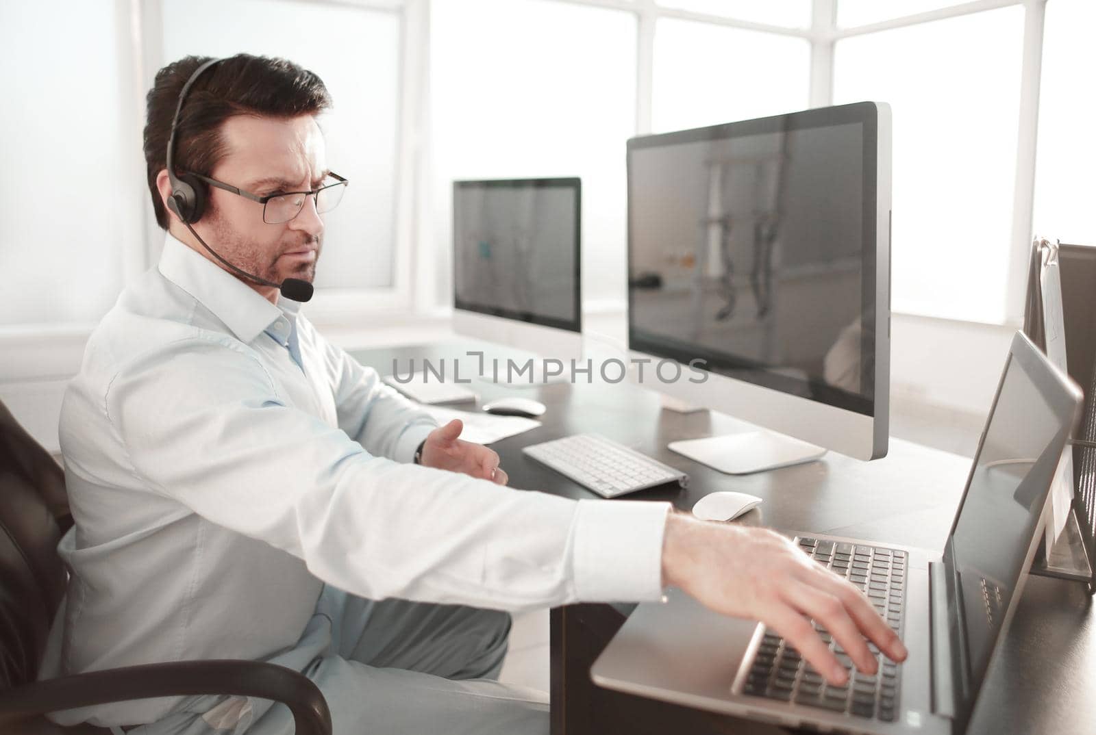 business center employee sitting at his Desk by asdf