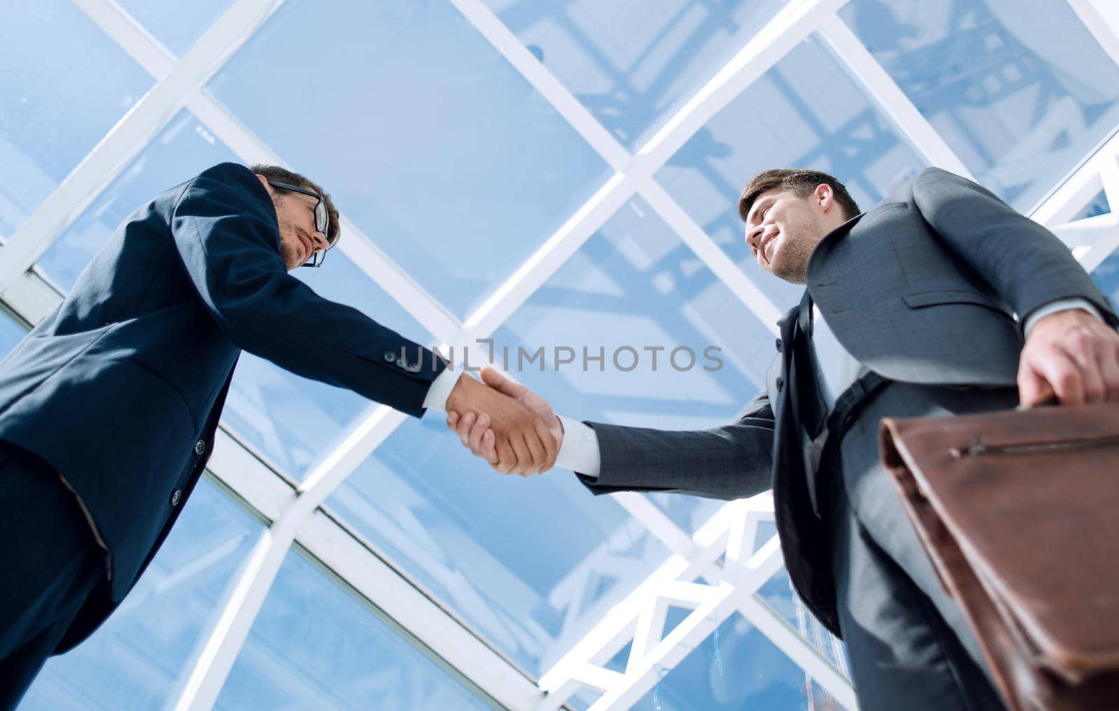 Businessman shaking hand to her partner by asdf