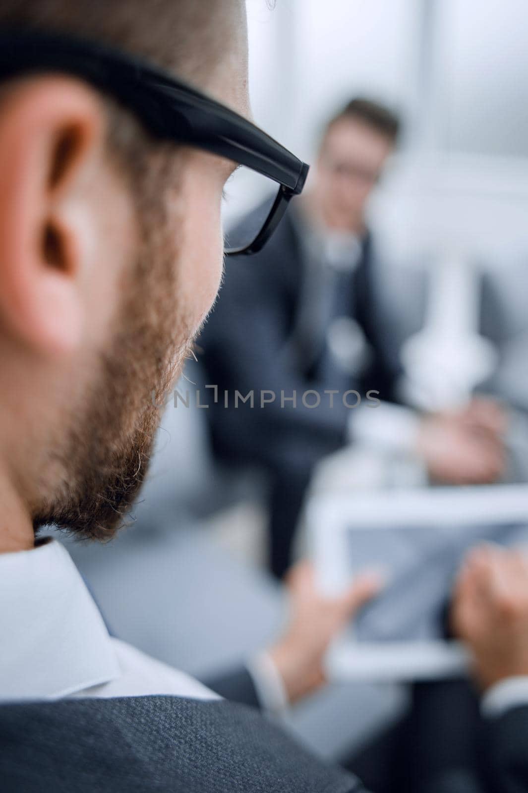 business background.blurred image of a businessman with a digital tablet.business concept