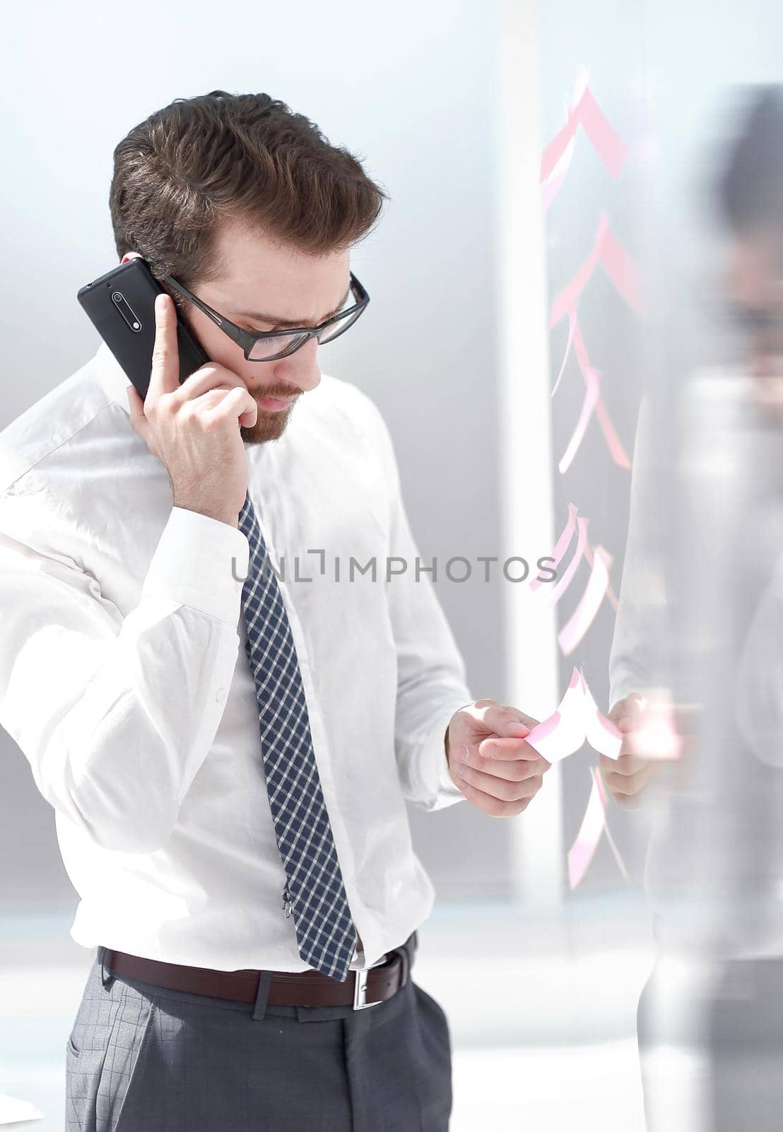 serious businessman talking on smartphone. by asdf