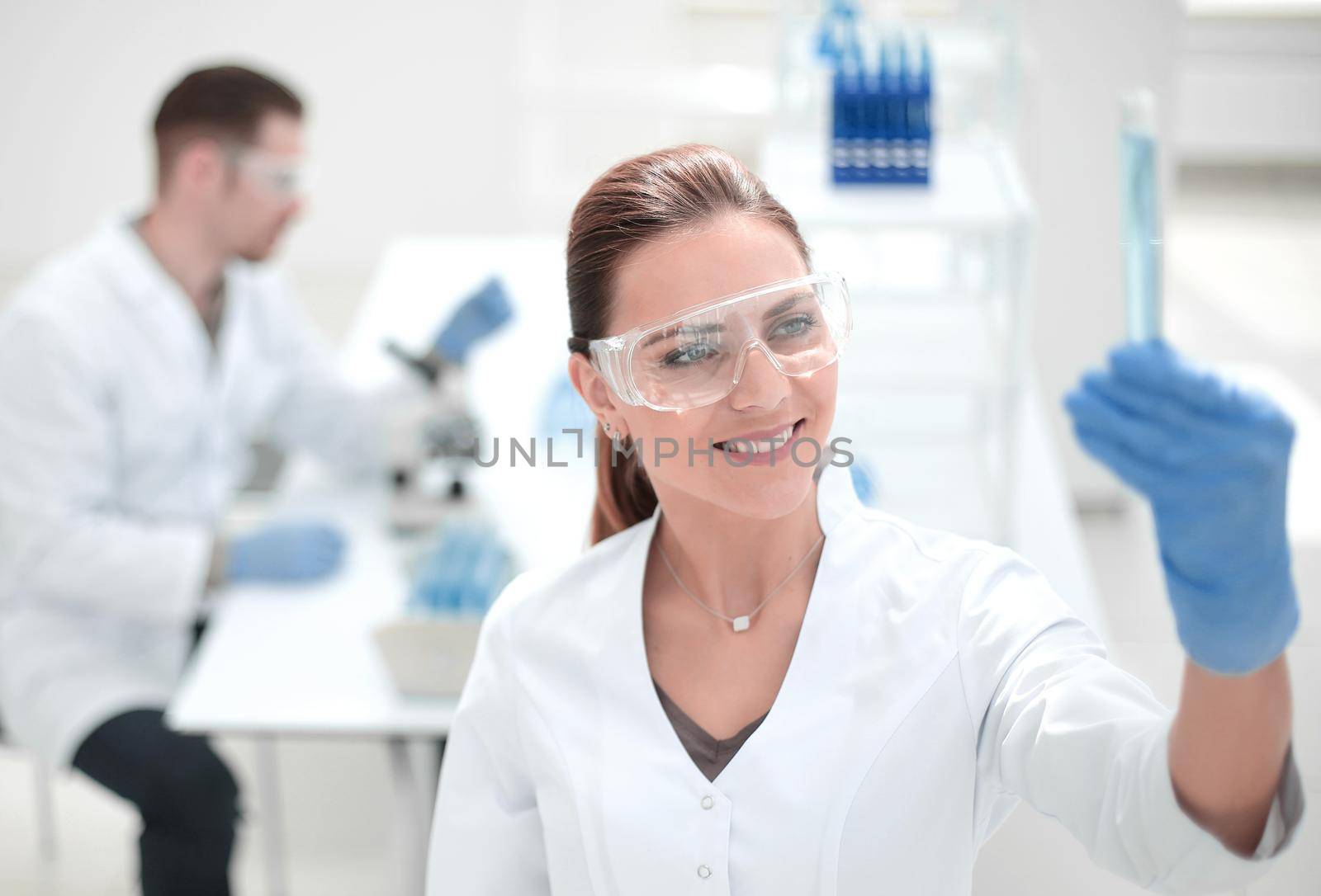 smiling female scientist standing in the lab by asdf