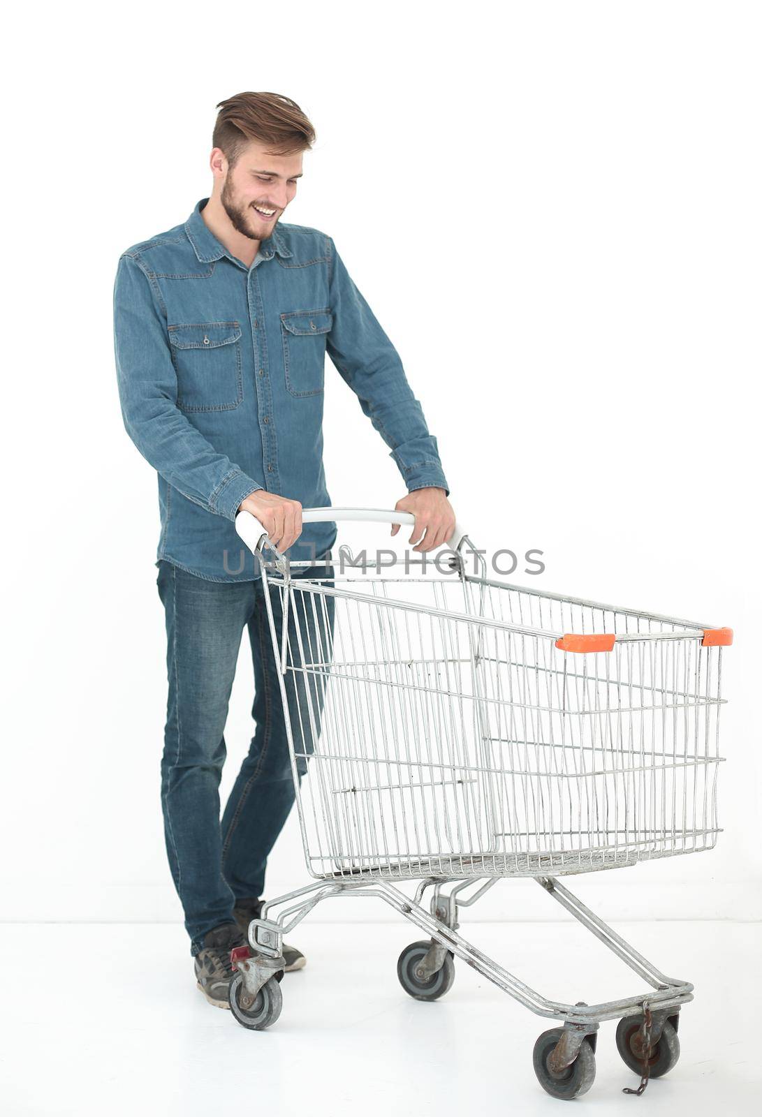 successful young man with a shopping cart.isolated on white background