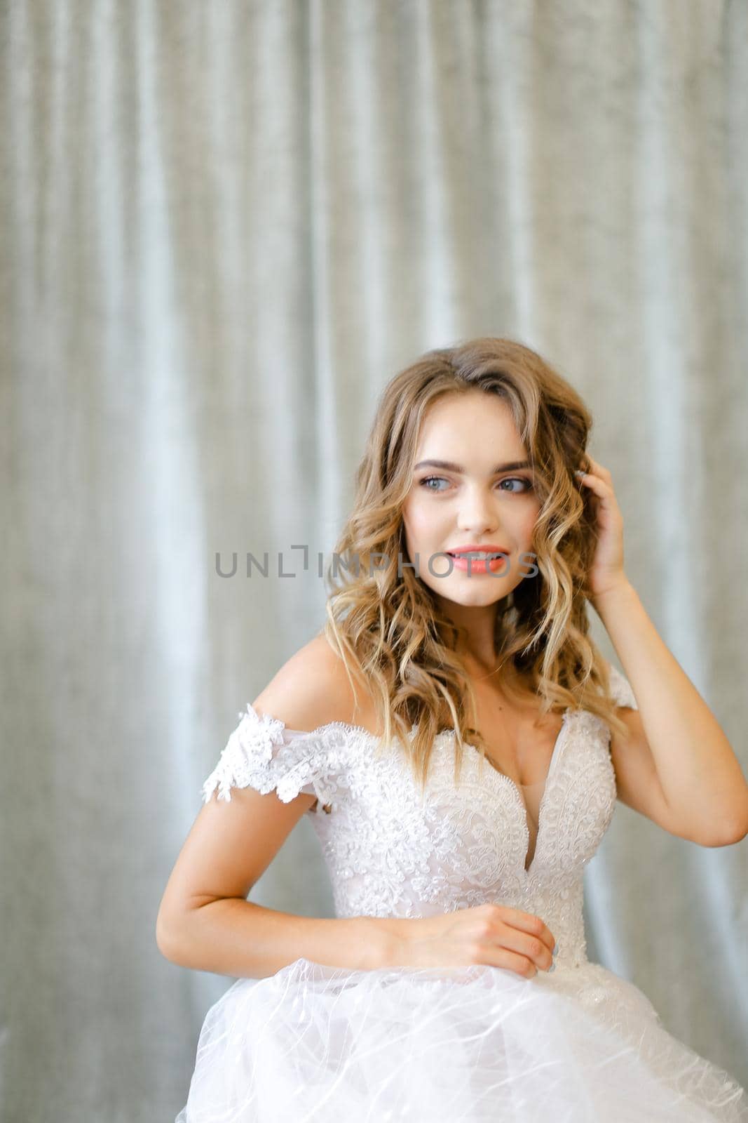 Portrait of nice caucasian bride in white dress at photo studio. by sisterspro