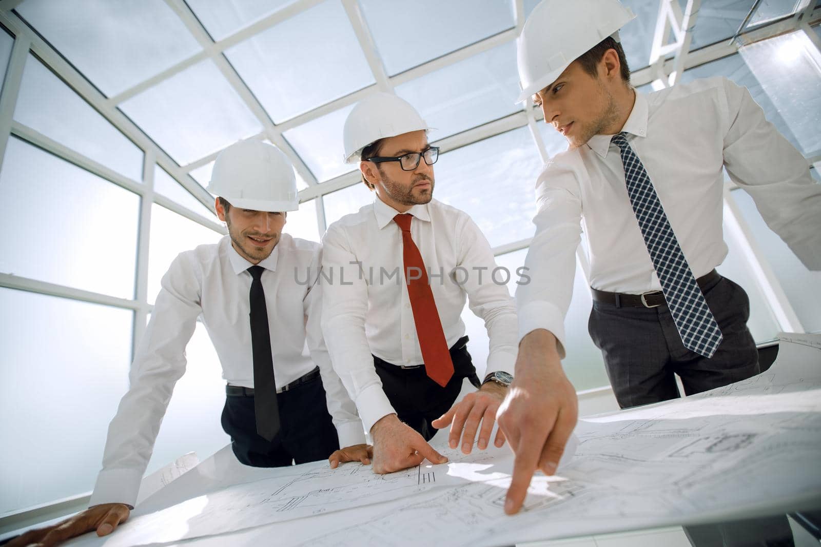 group of architects discussing sketches .the concept of professionalism