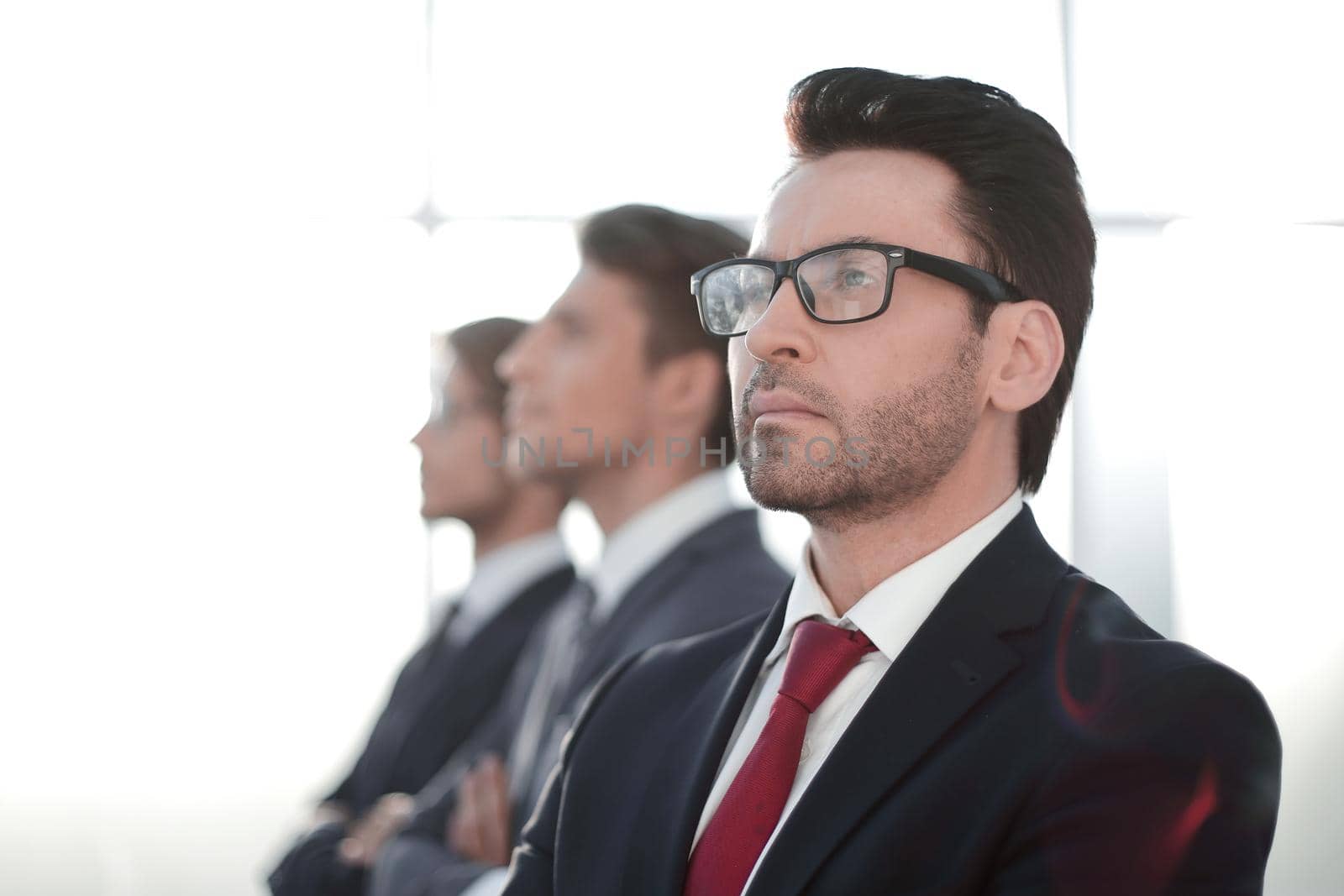 side view.a group of business partners looking at a copy space.business concept