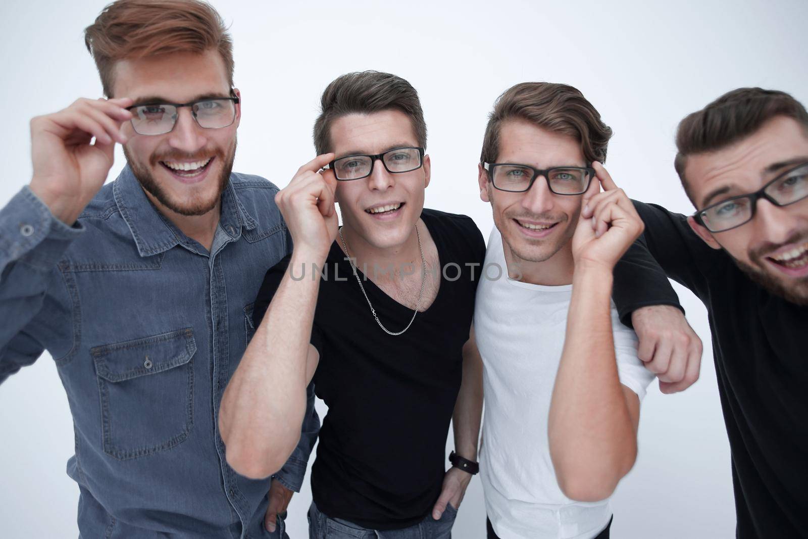 a group of men in casual clothes adjusting their glasses at the same time