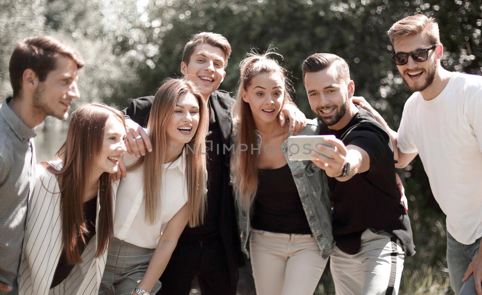 group of friends takes a selfie on the background of the city Park.people and technology