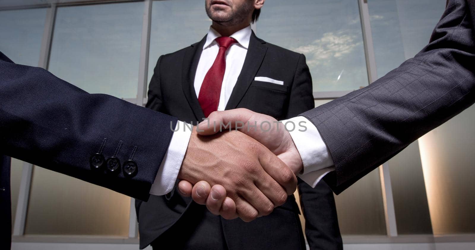 business partners shake hands by asdf