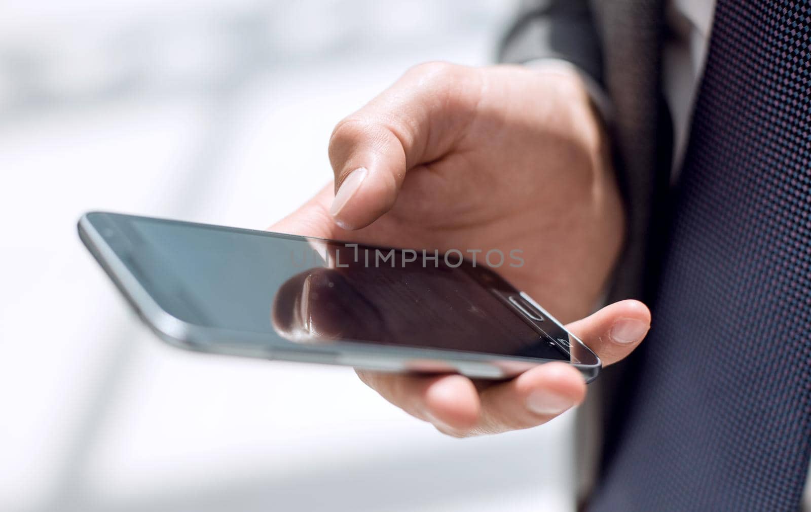 close up.businessman holding a smartphone by asdf