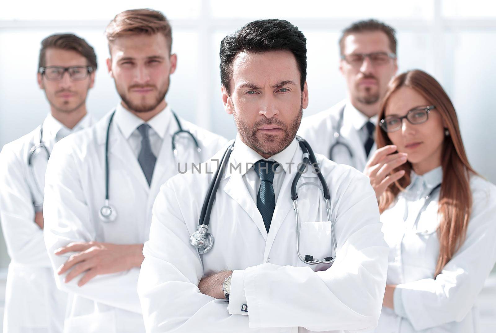 portrait of doctor and medical staff standing in the office . photo with copy space