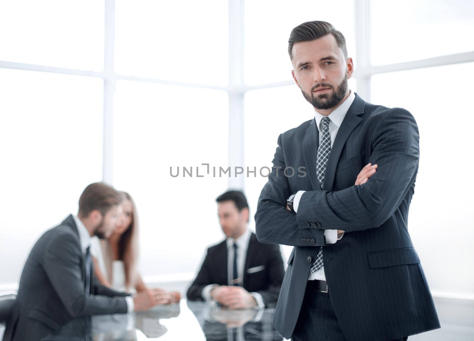 modern businessman standing in a bright office by asdf