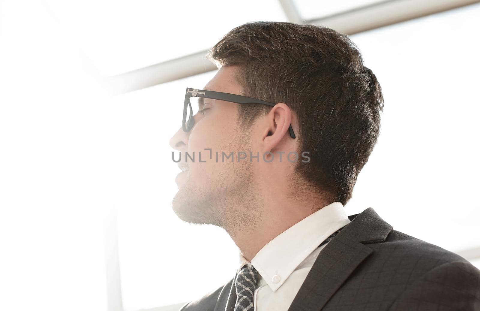 close up.modern young businessman looking for copy space by asdf