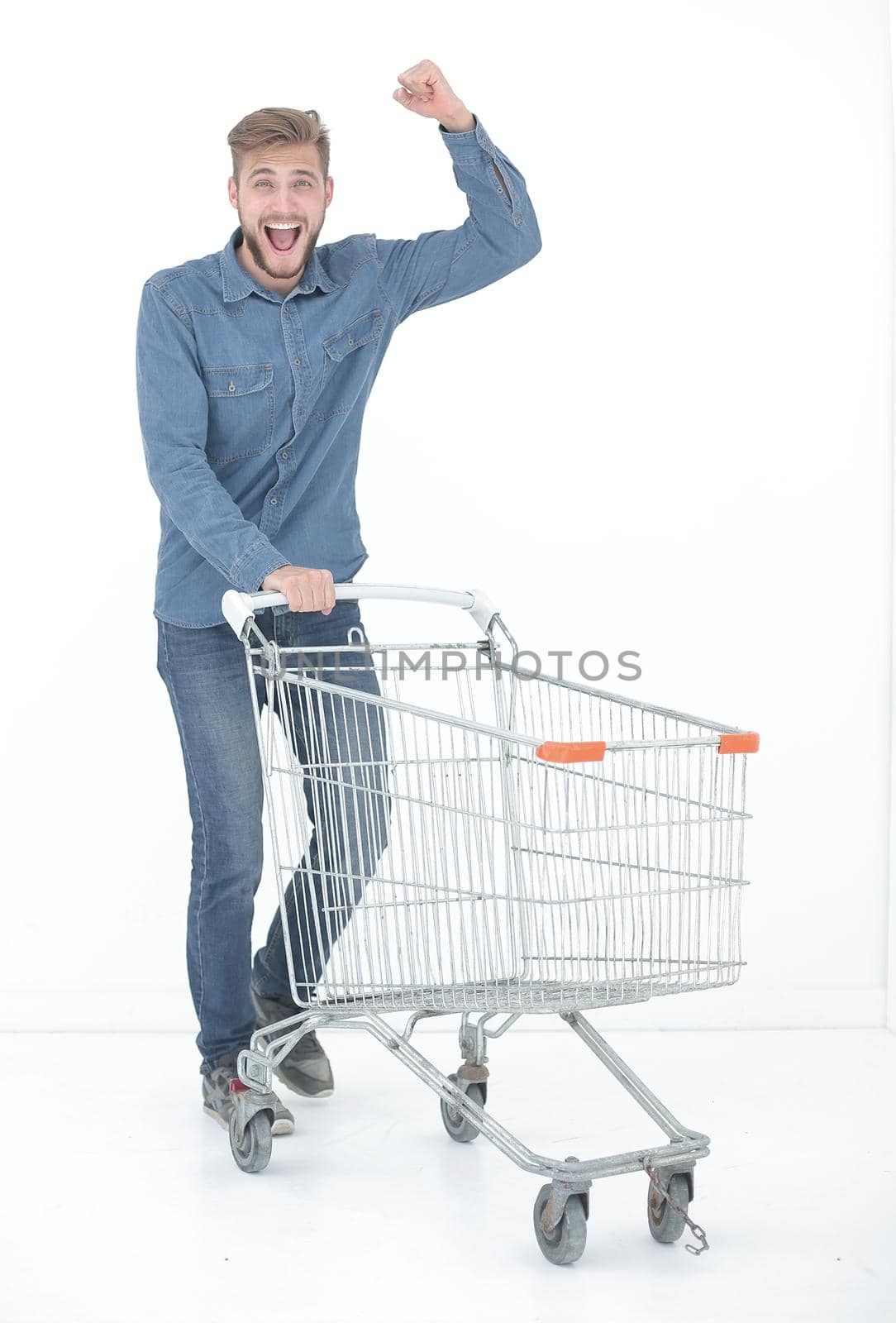 Full length portrait of a happy man running with a shopping trolley by asdf