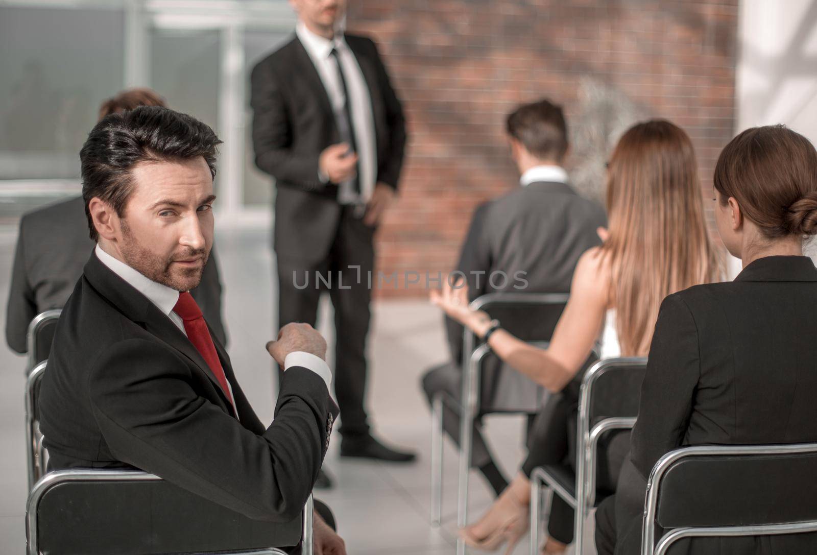 business conference listener sitting in the conference room and looking at the camera