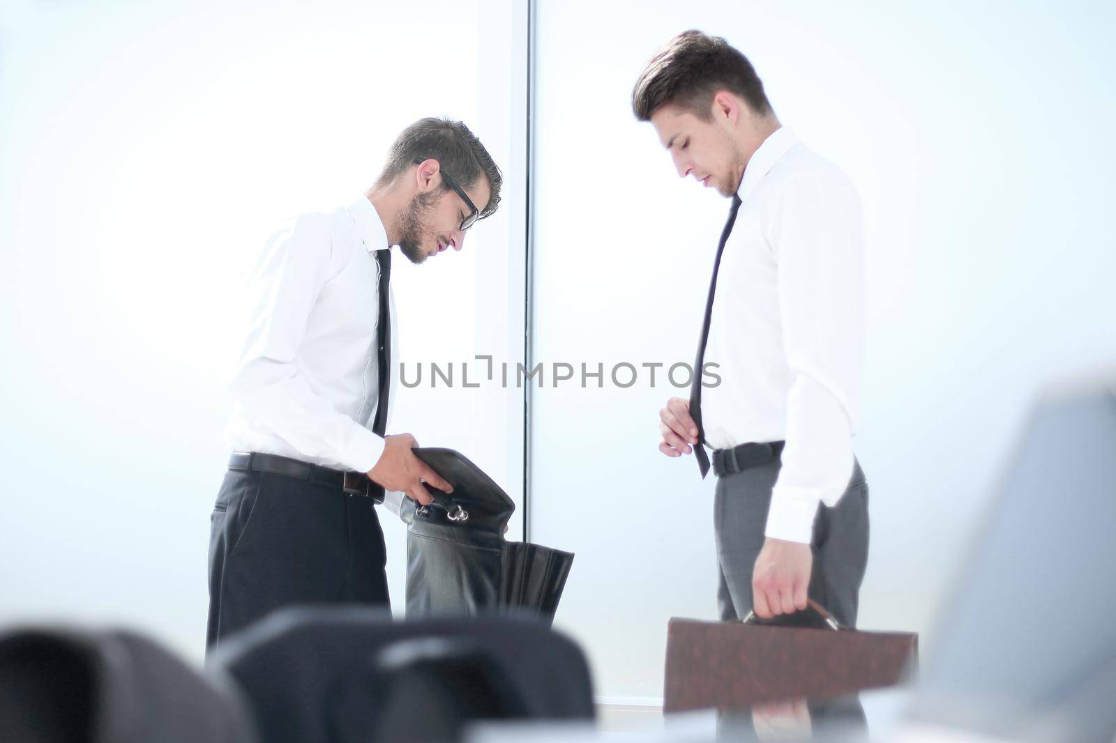 Businessman looking at a document in his briefcase