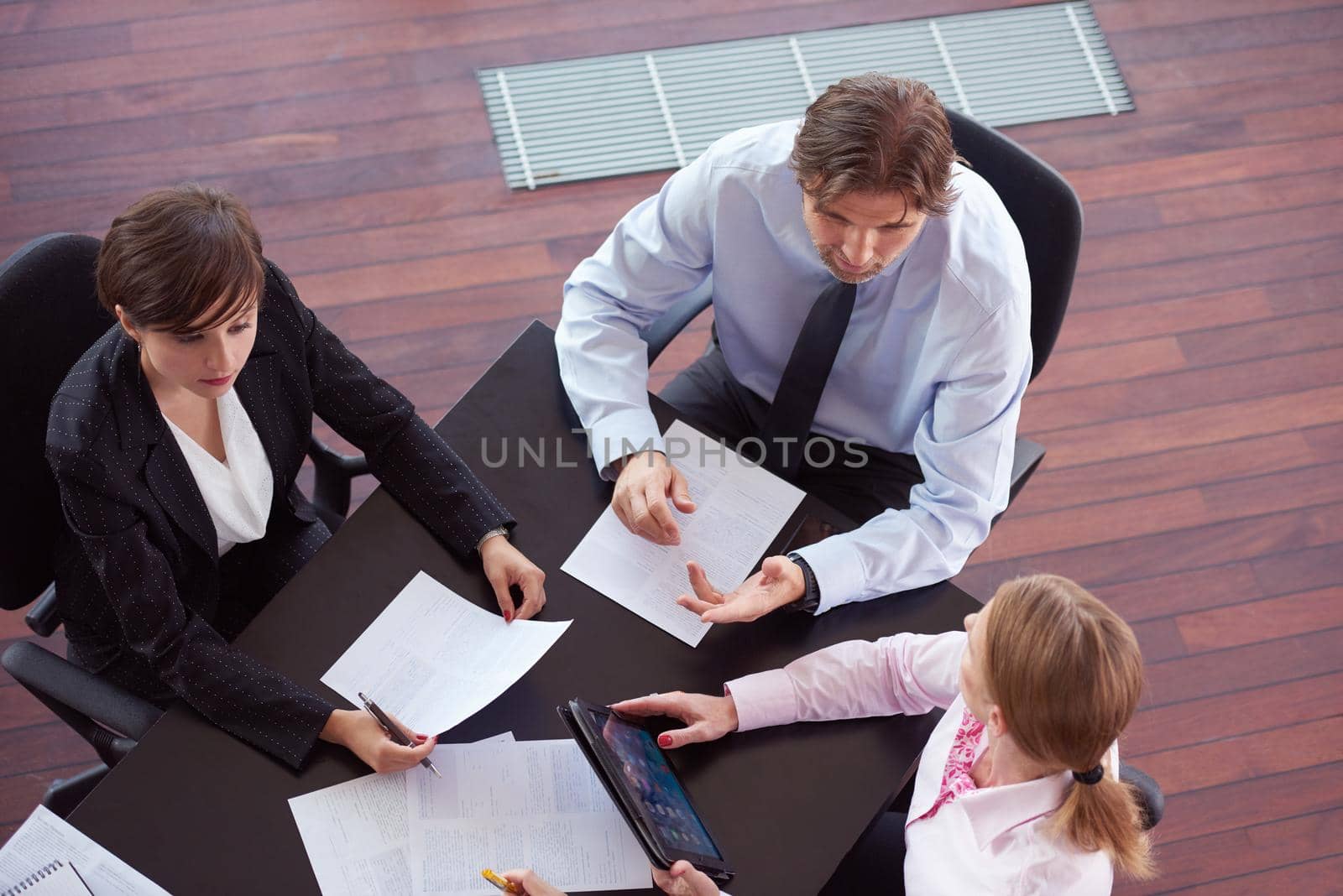 top view of  business people group on meeting, working in modern bright office indoor with tablet computer