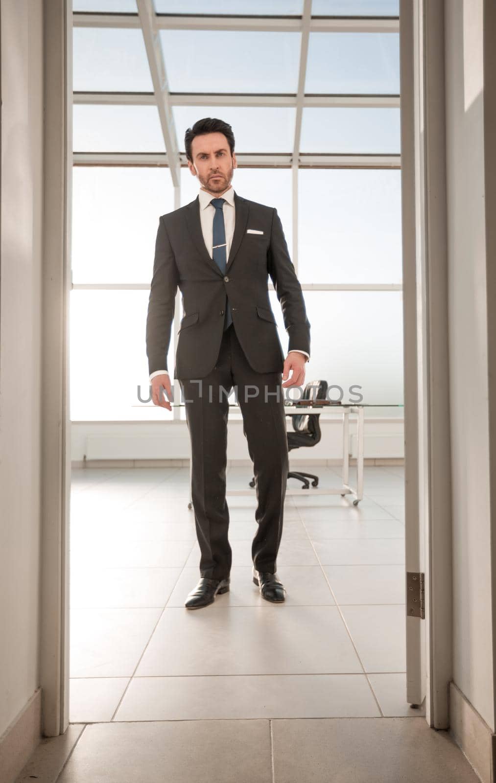 serious businessman walks into his office by asdf