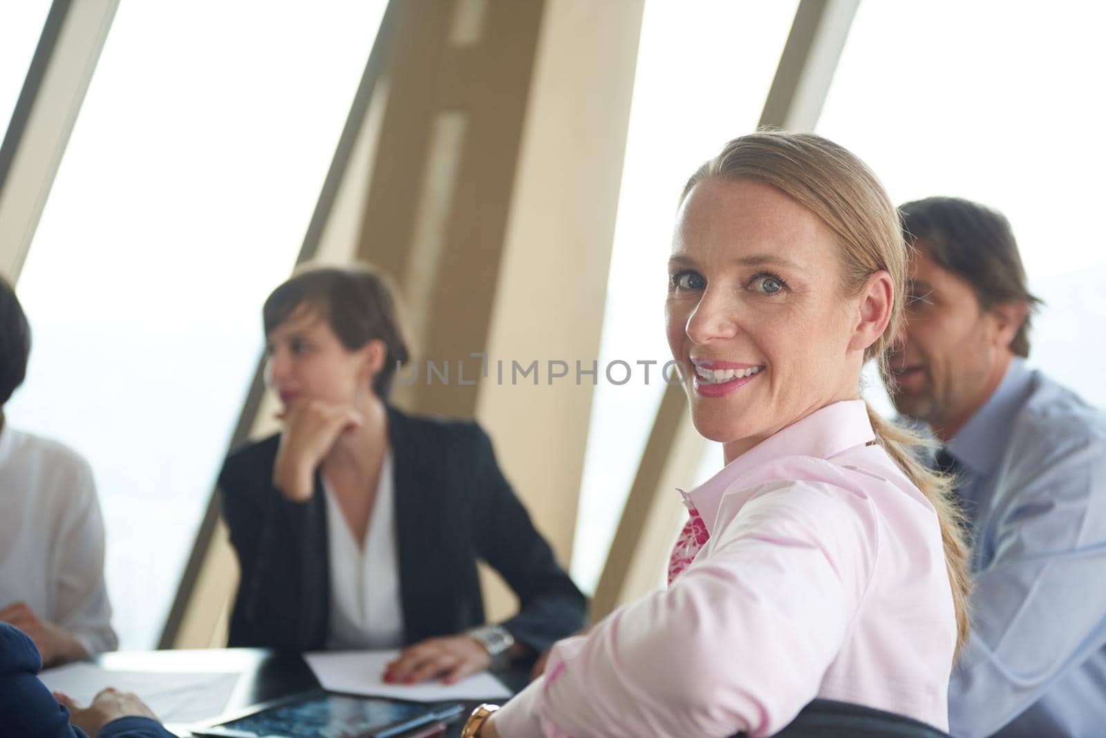 business woman on meeting, people group in background at modern bright office indoors