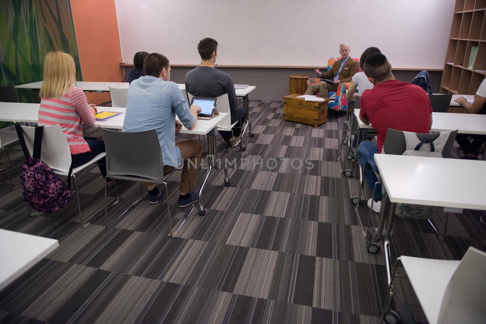 group of students study with professor in modern school classroom