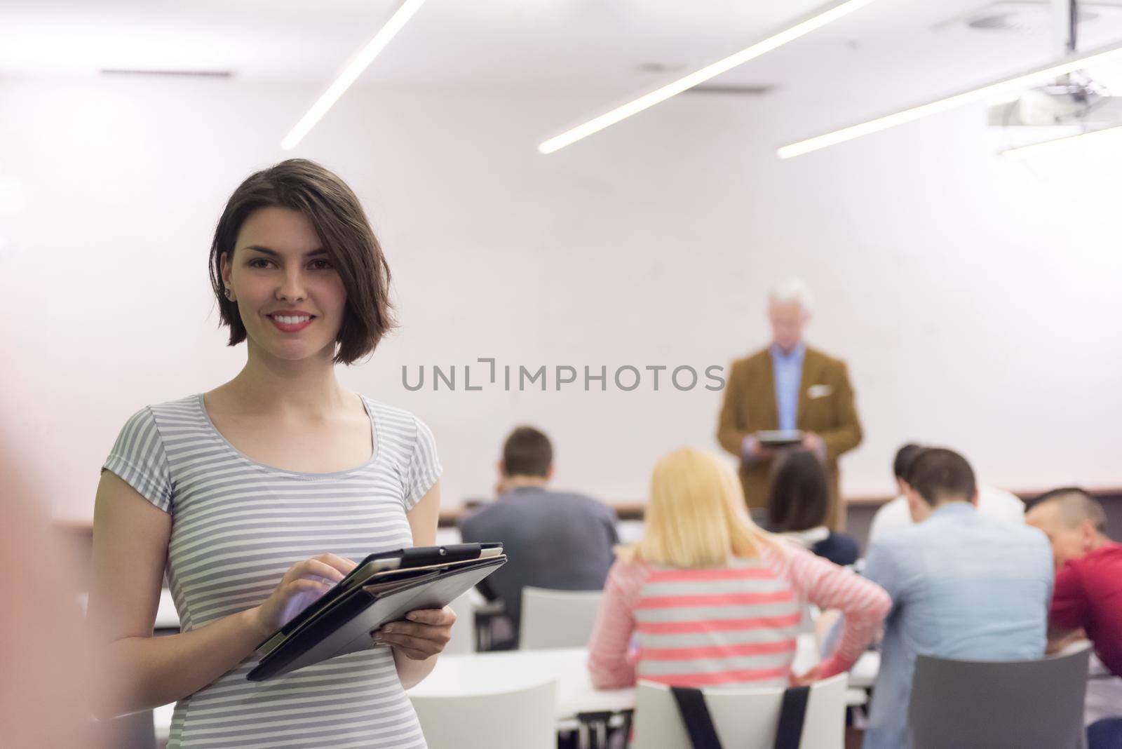 portrait of happy female student in classroom by dotshock