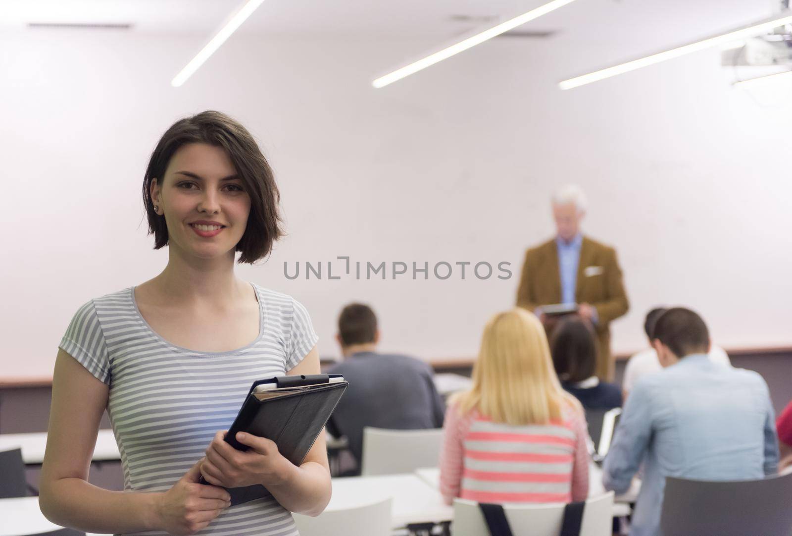 portrait of happy female student in classroom by dotshock