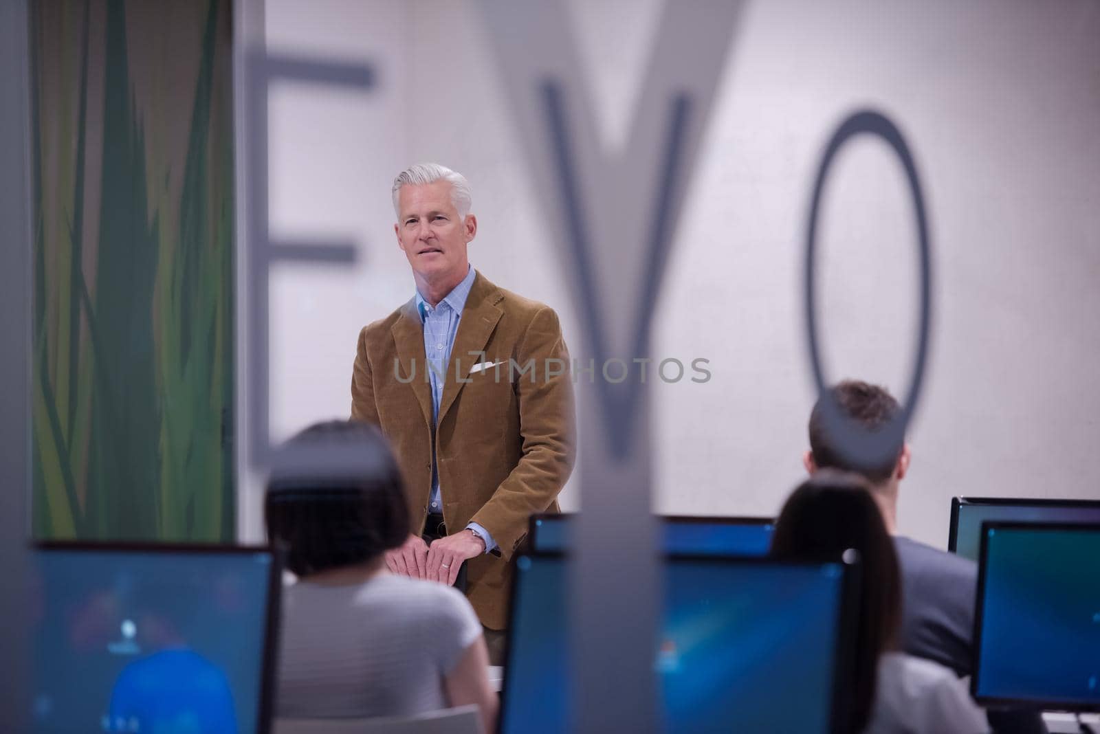 teacher and students in computer lab classroom by dotshock