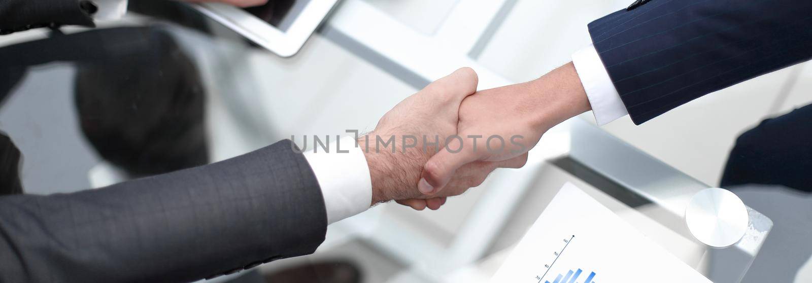 close up. investor and businessman shaking hands.