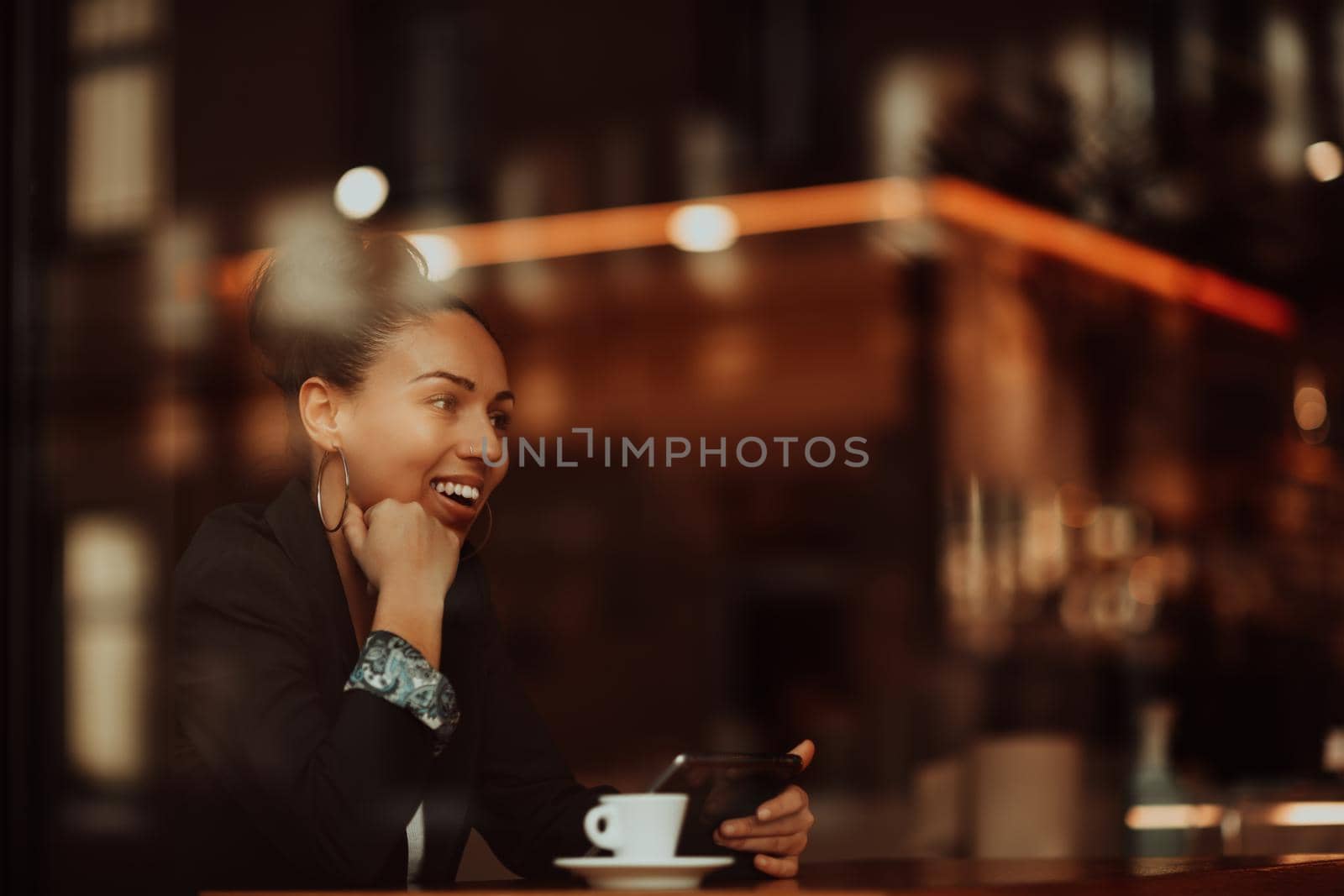 Latina woman sitting in a cafe on a break from work by dotshock
