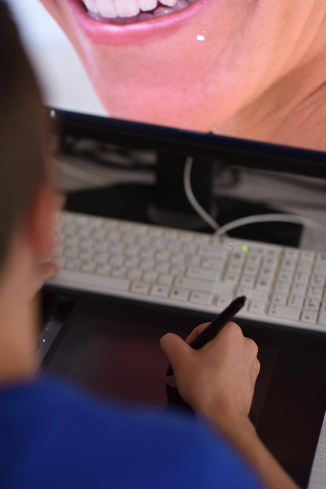 Young graphic designer working on a digital tablet and a computer