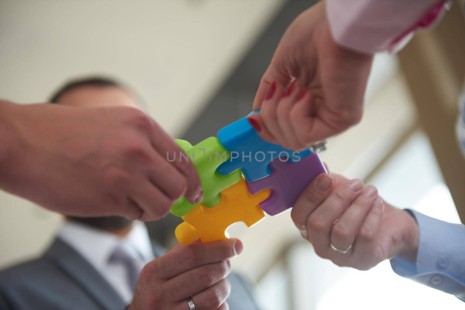 business people group assembling jigsaw puzzle by dotshock