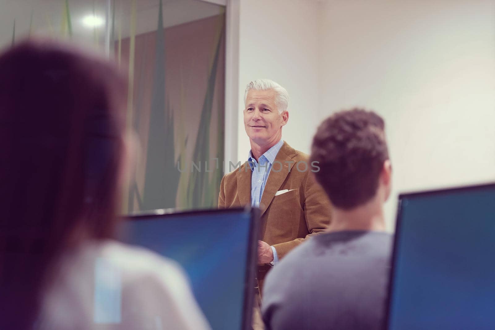 teacher and students in computer lab classroom by dotshock