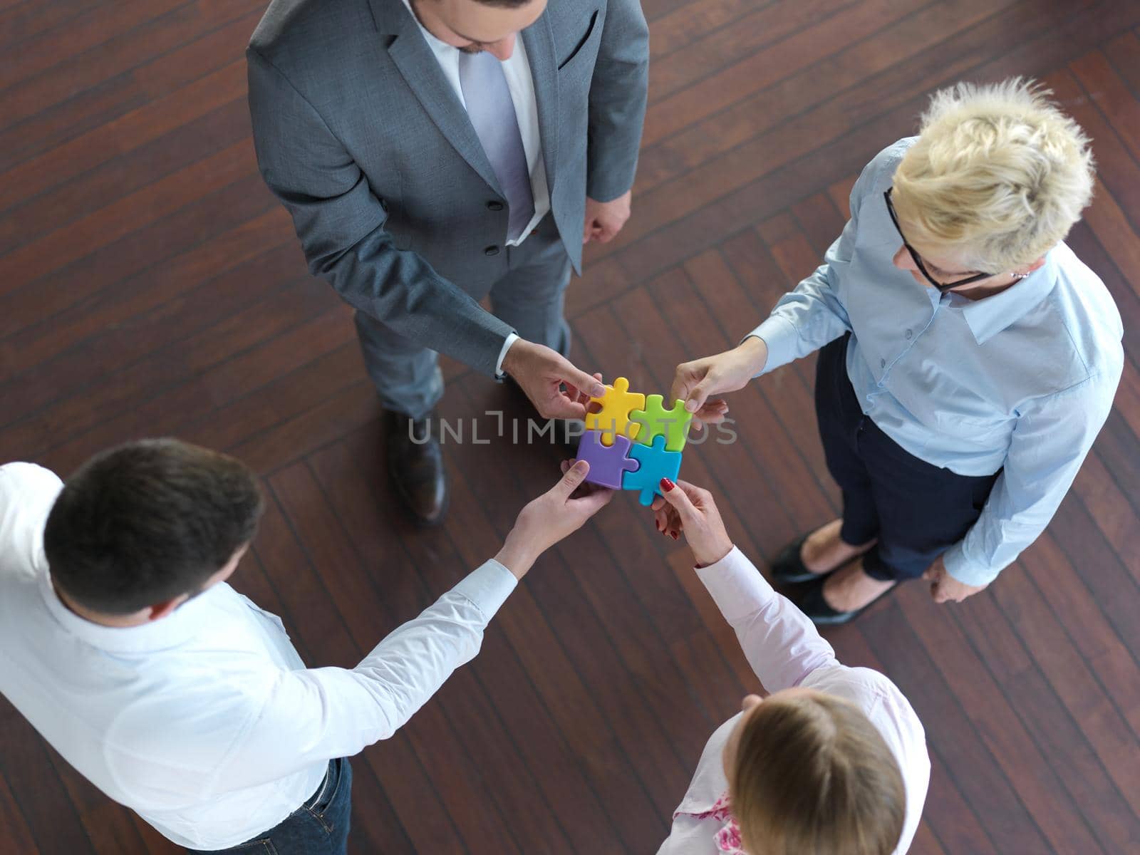 business people group assembling jigsaw puzzle by dotshock