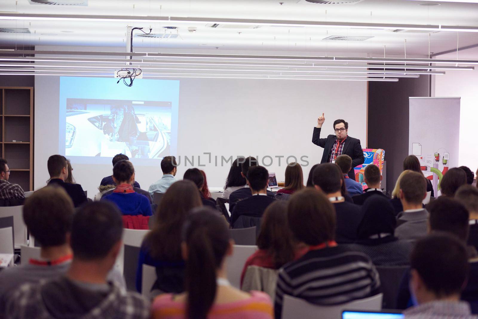 speaker on education conference presentation at modern startup interior