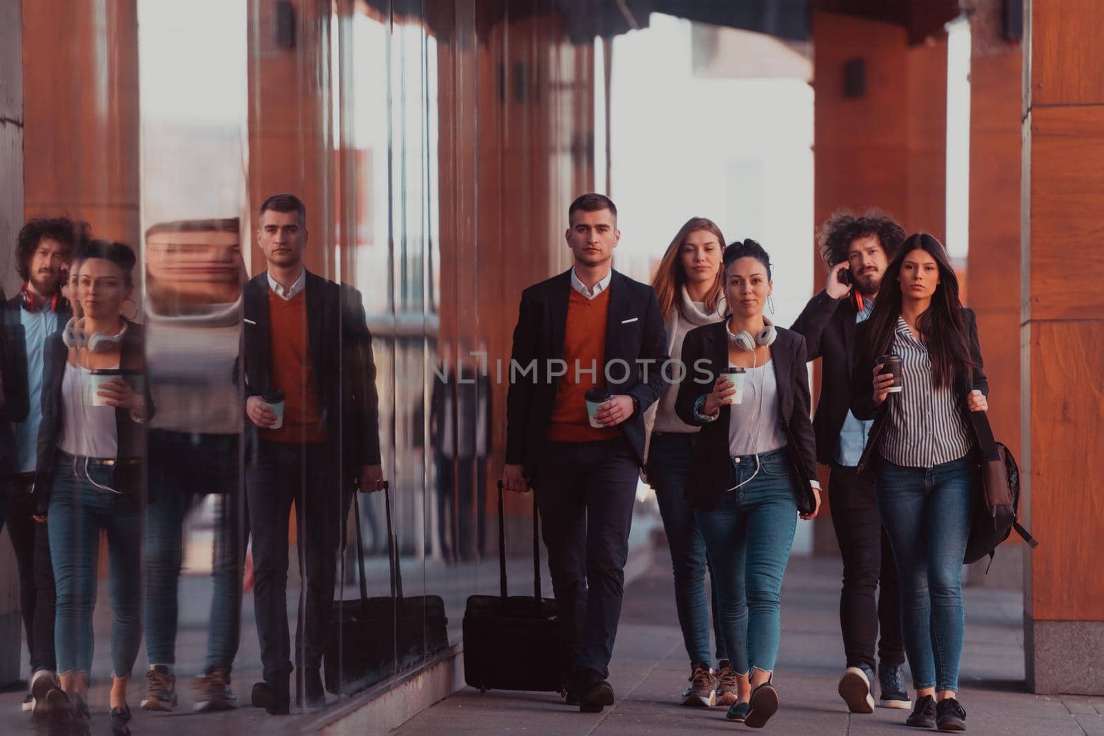Elegant businesspeople walking in a modern city.. by dotshock