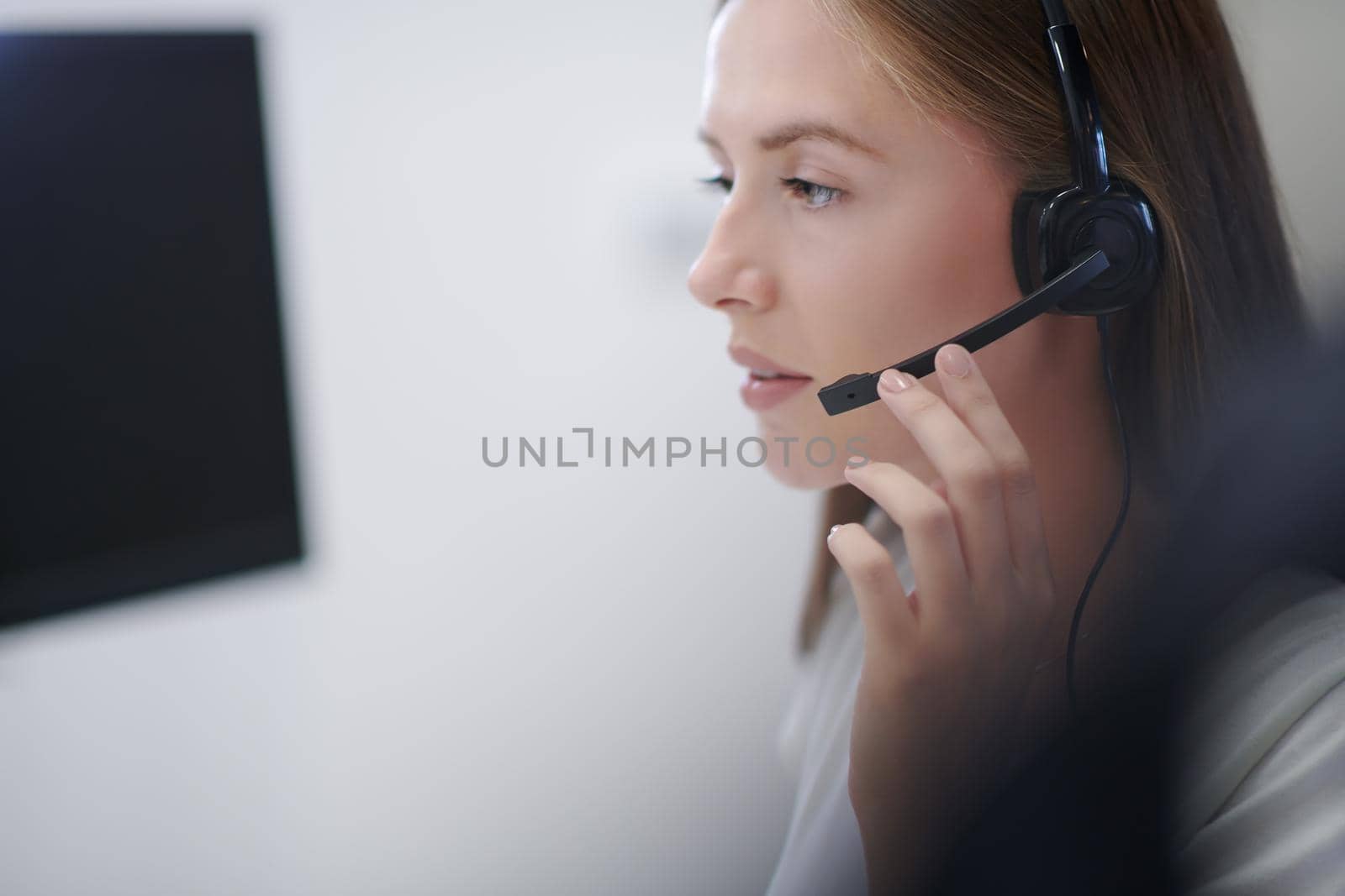 business and technology concept - helpline female operator with headphones in call centre  Business woman with headsets working in a call center