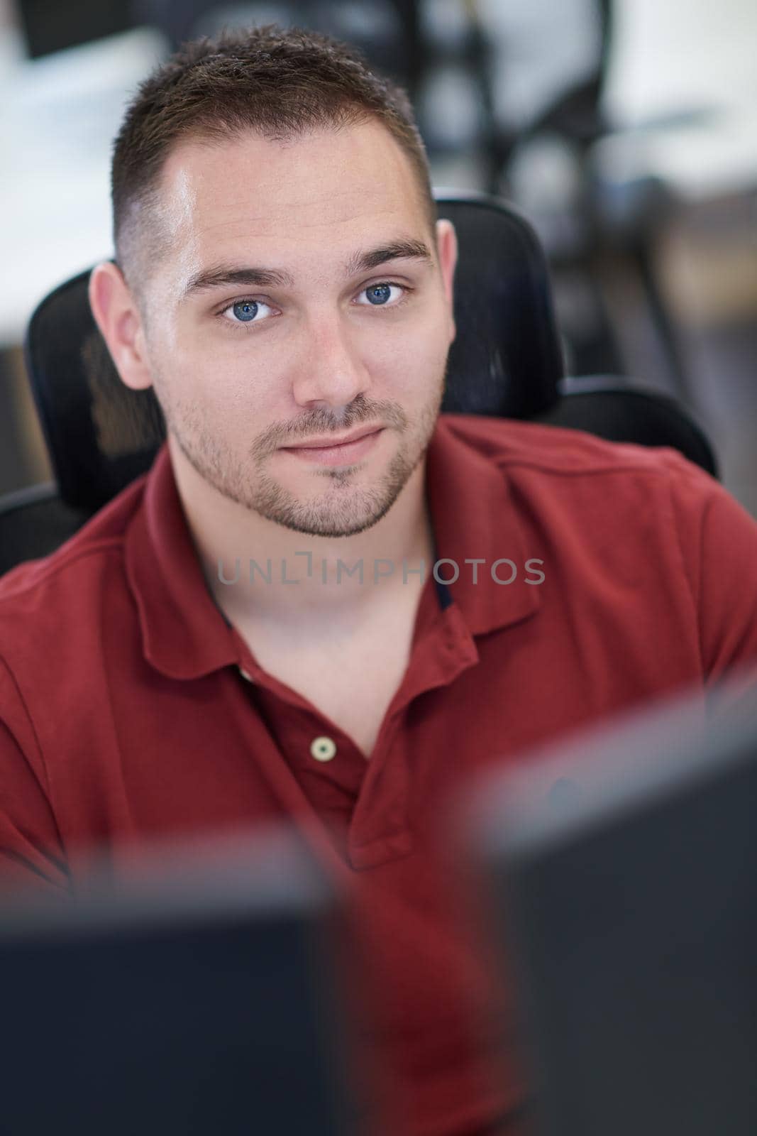 casual business man working on desktop computer in modern open plan startup office interior