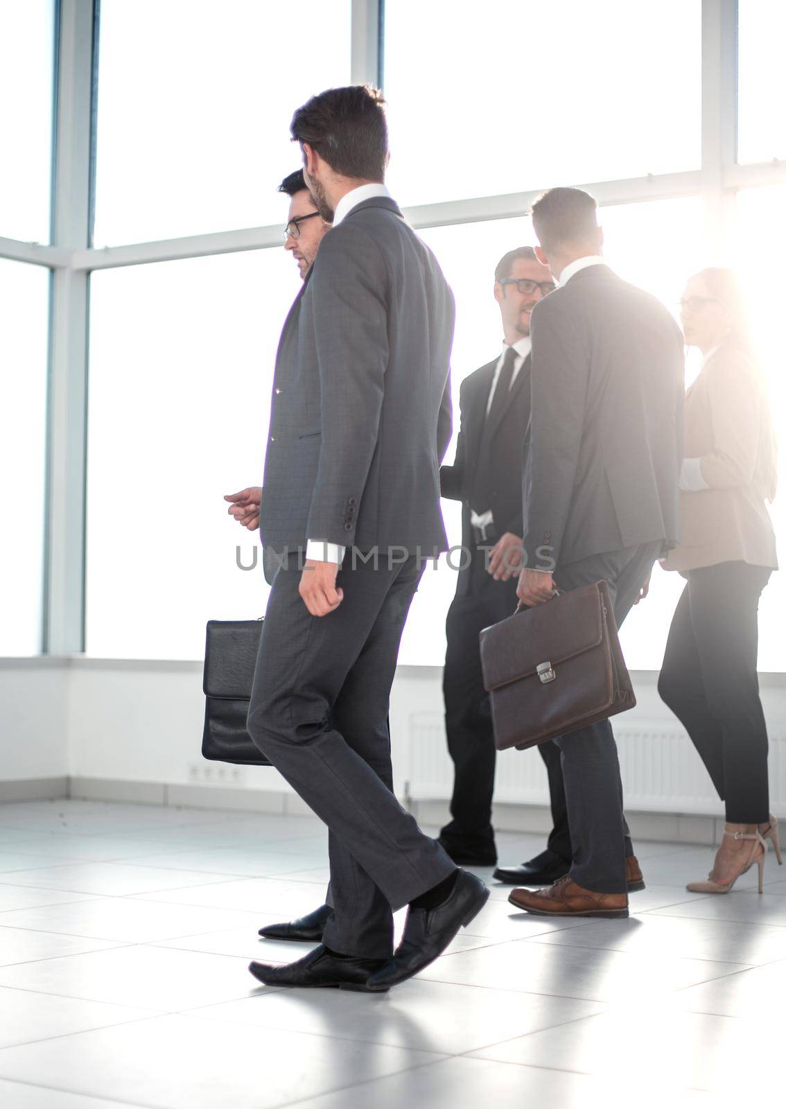 Businesspeople walking in the office background. by asdf