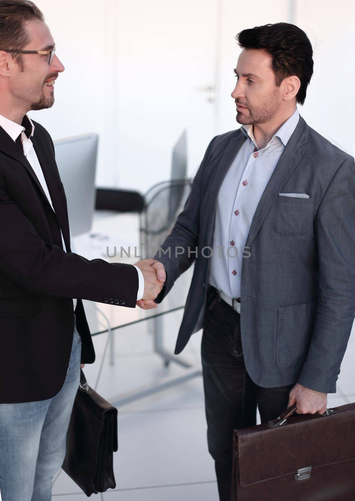 welcoming handshake of a businessman with a lawyer. business concept