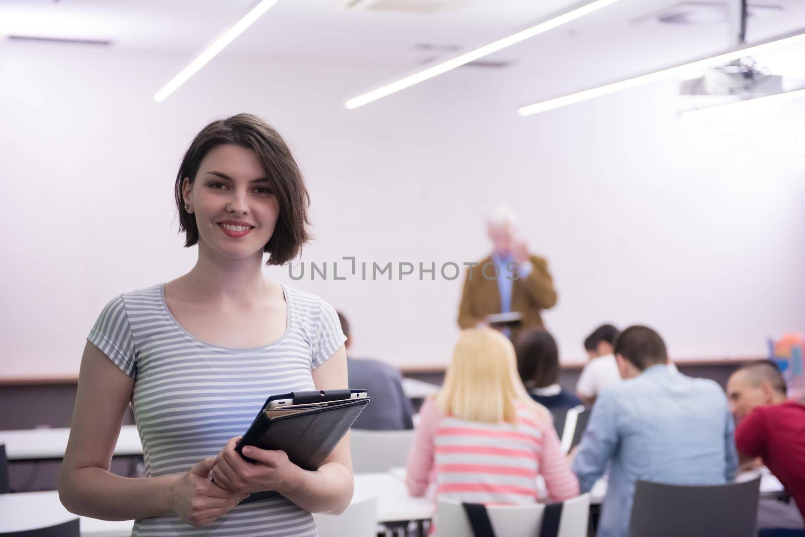 portrait of happy female student in classroom by dotshock