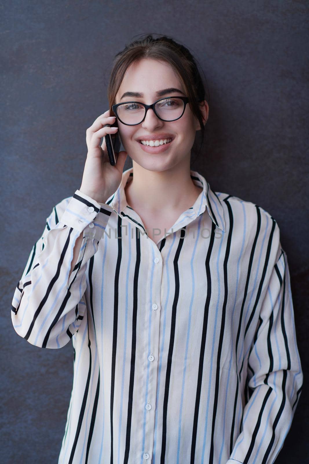 startup businesswoman in shirt with a glasses using mobile phone by dotshock