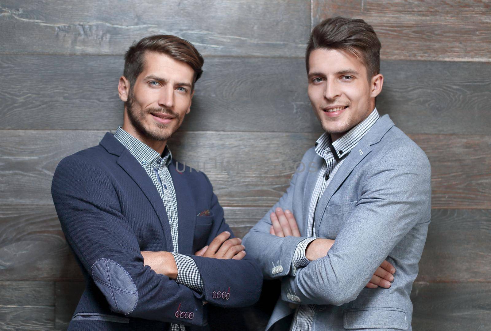 Portrait of two handsome businessmen CEO and executive confident grin