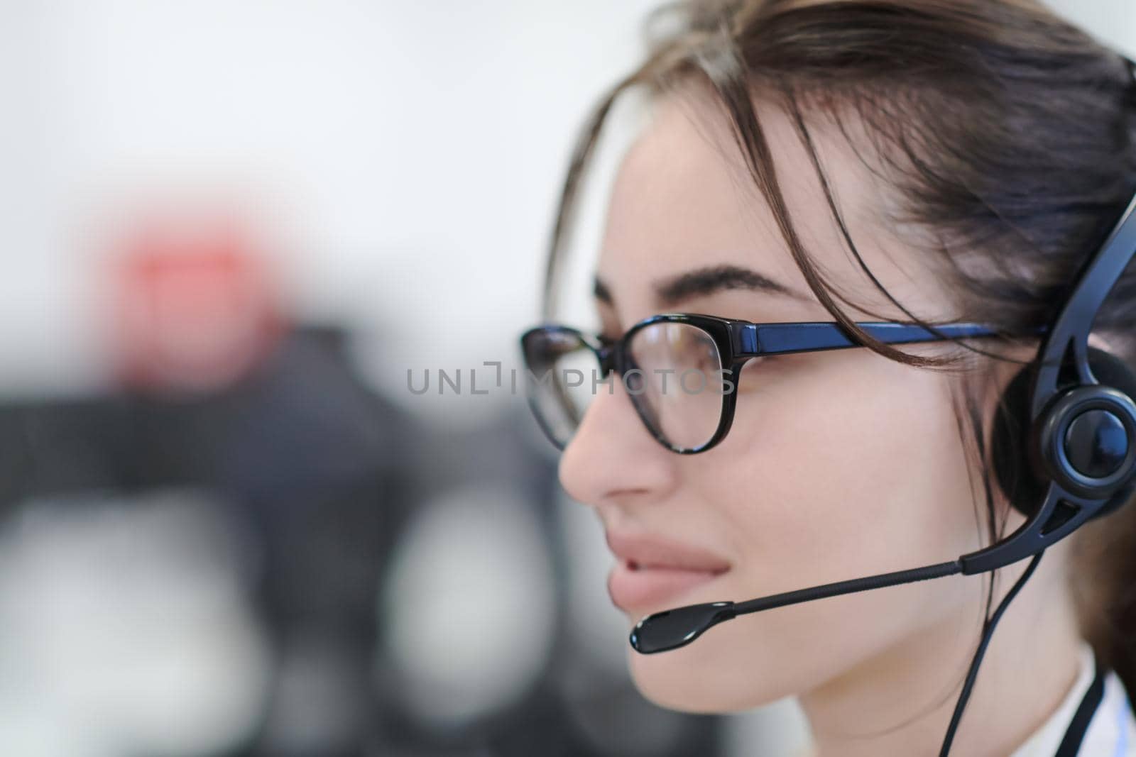 Business woman with headsets at work by dotshock