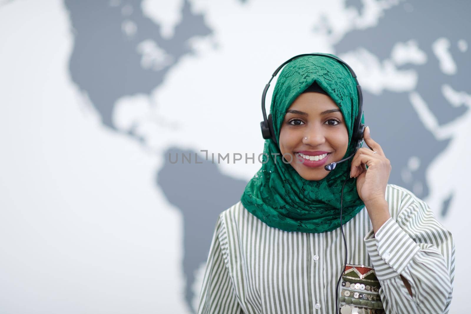 African muslim female with phone headset helping and supporting online by dotshock
