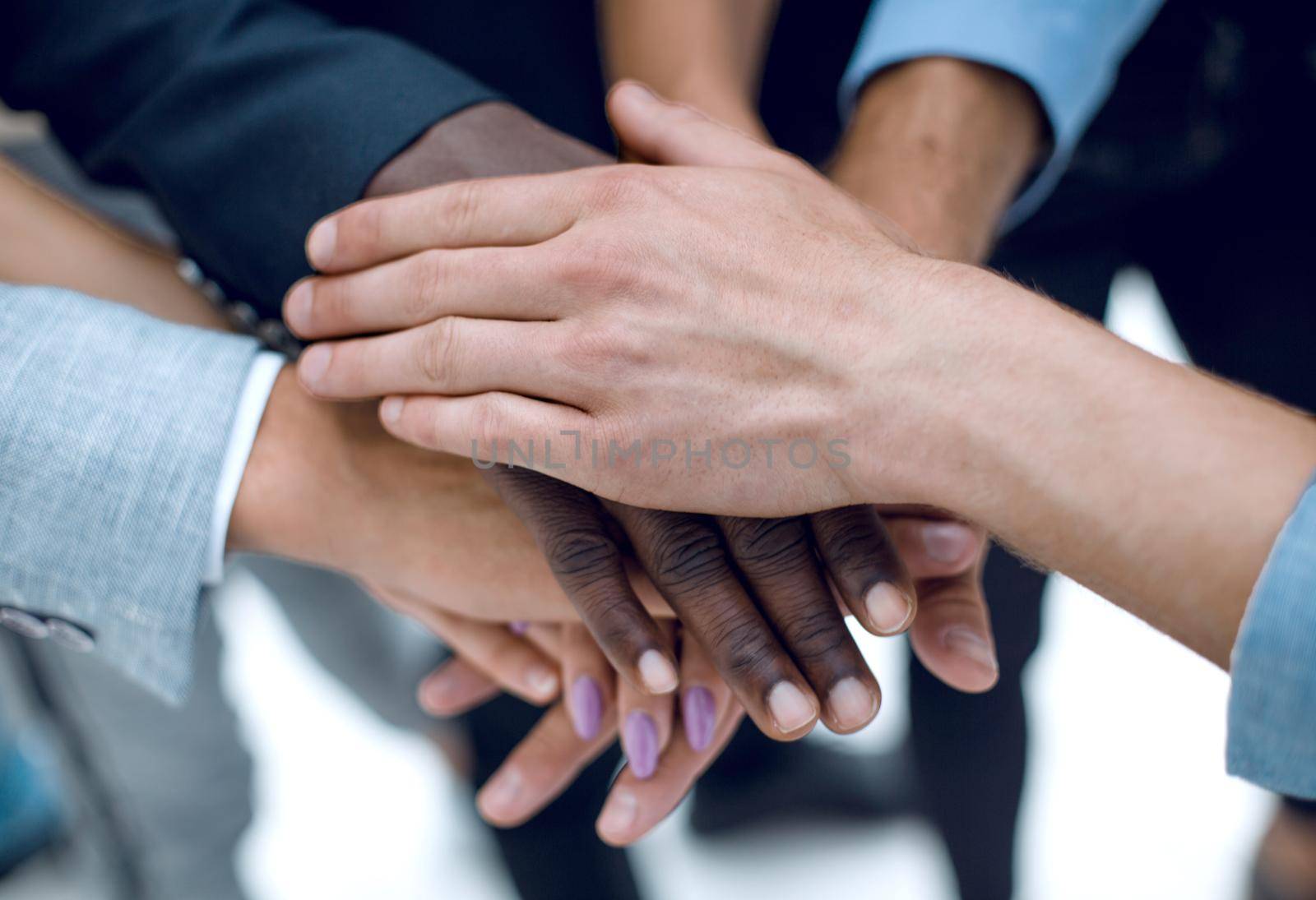 Cropped shot of a group of businesspeople piling their hands on top of each other