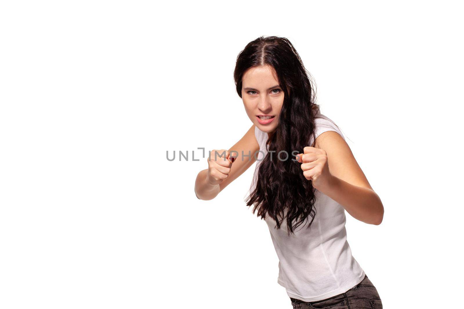 Beautiful woman shows her fists on white background