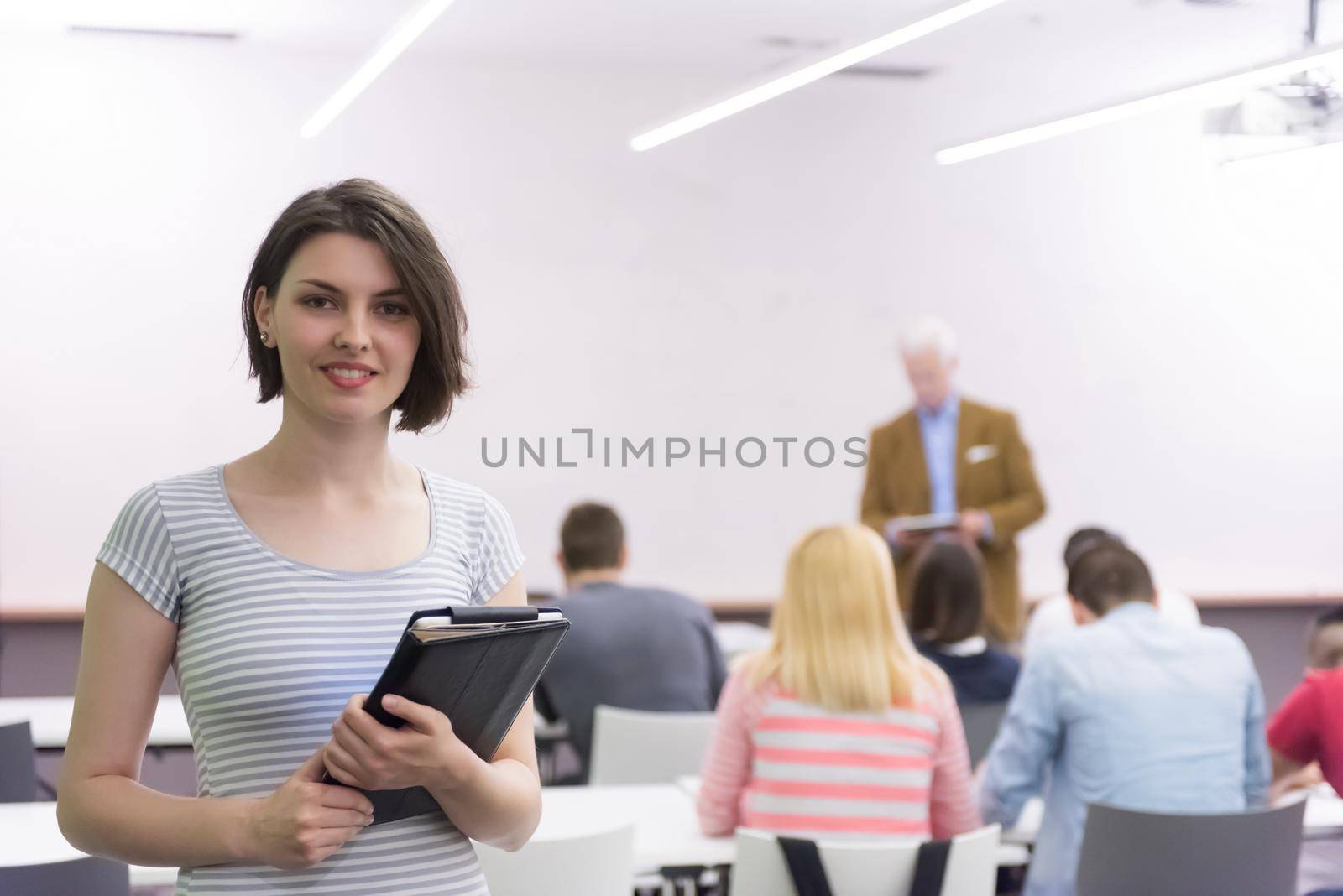 portrait of happy female student in classroom by dotshock