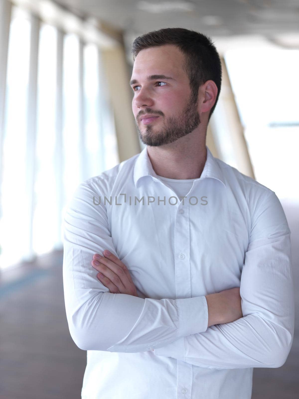 portrait of young  business man with beard at modern office by dotshock