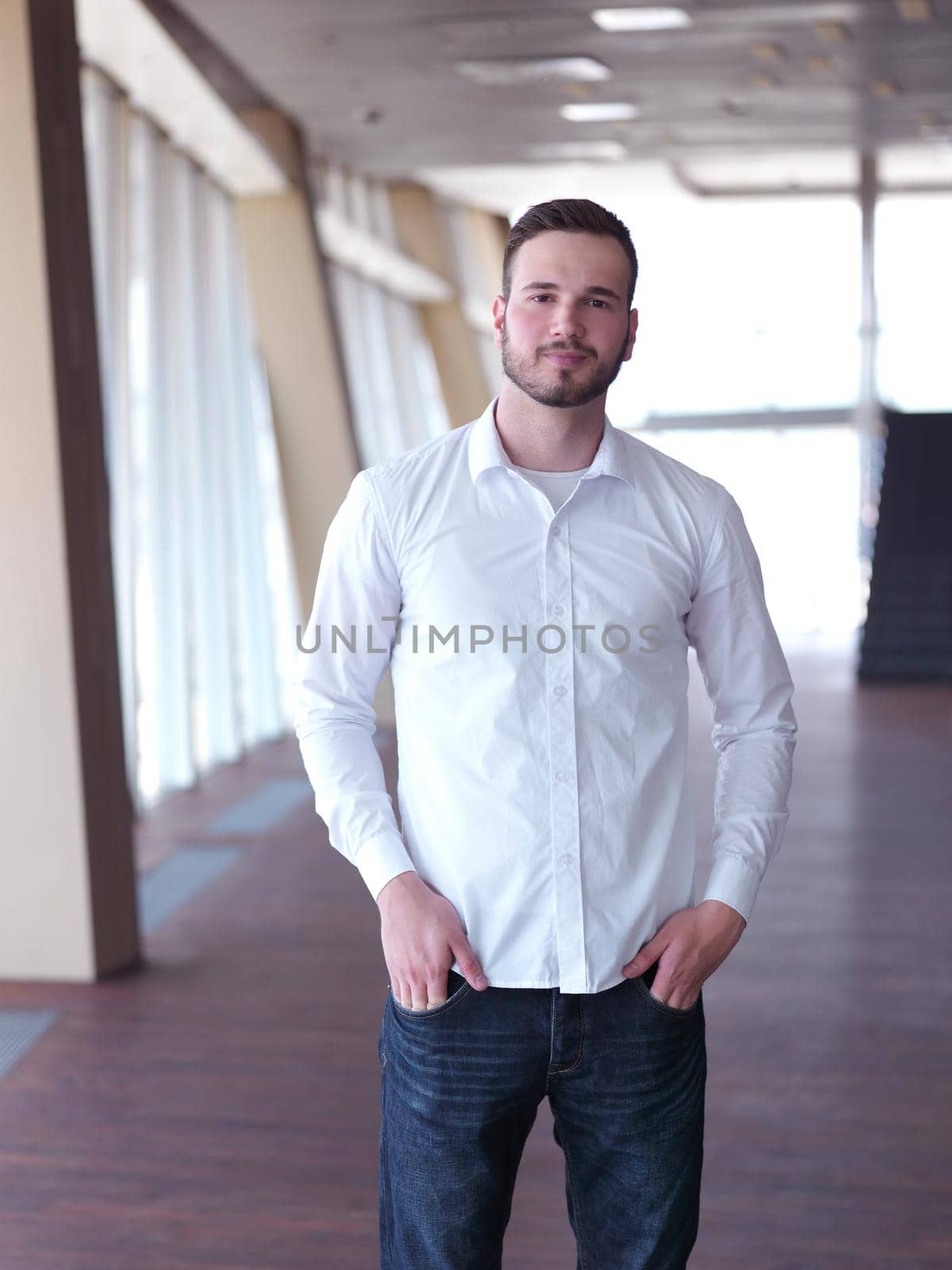 portrait of young  business man with beard at modern office by dotshock